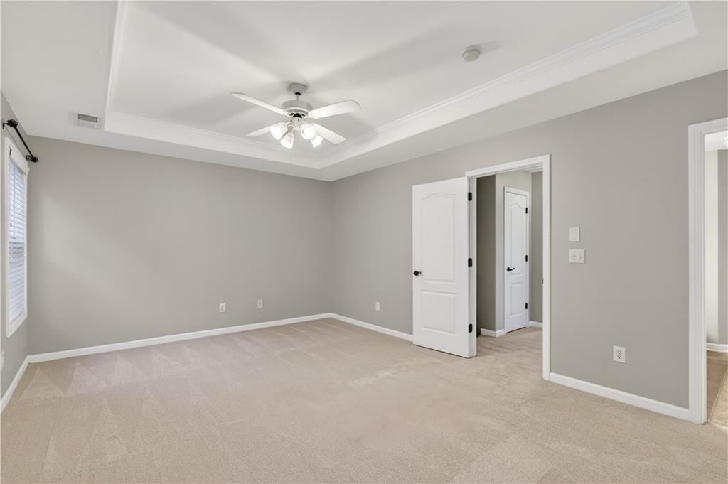 1186 Lake Point Way Suwanee, GA 30024 - Photo 20 of 35 a view of an empty room with a ceiling fan