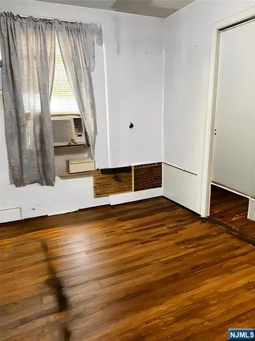 a view of a room with wooden floor