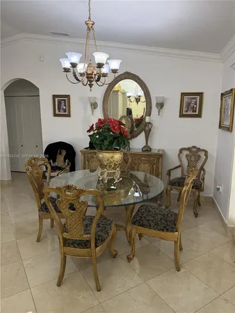 a view of a dining room with furniture and chandelier