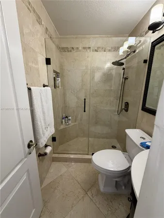 a bathroom with a toilet and a shower