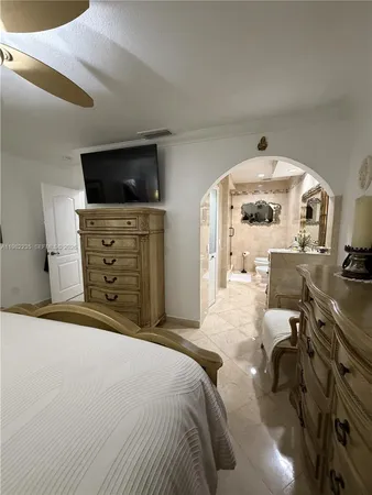 a bedroom with a bed and flat screen tv