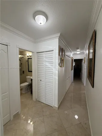 a view of a hallway with bathroom