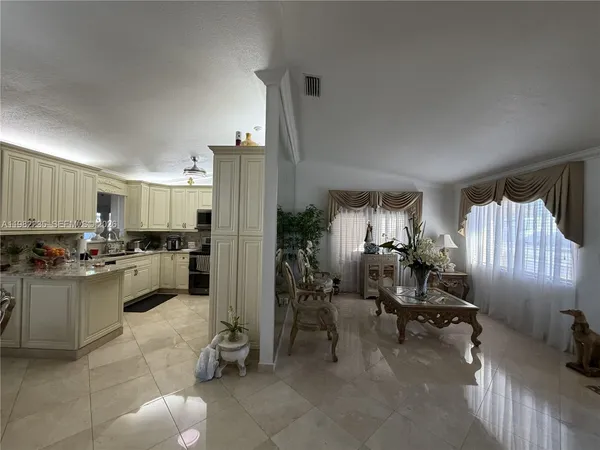 a kitchen with sink refrigerator and cabinets