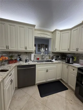 a kitchen with a cabinets and white appliances