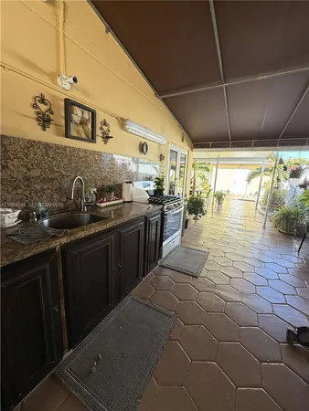 a kitchen with stainless steel appliances a sink stove and cabinets