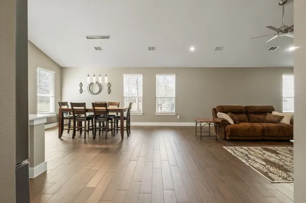 a living room with furniture and wooden floor