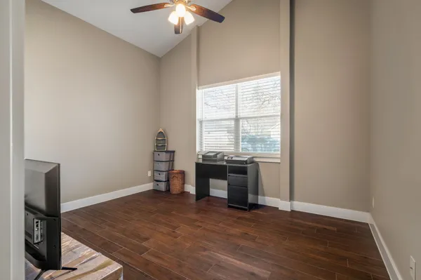 a view of a workspace with furniture and a window