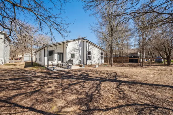 a view of a yard with a large tree
