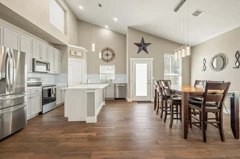 a view of kitchen with cabinets and wooden floor