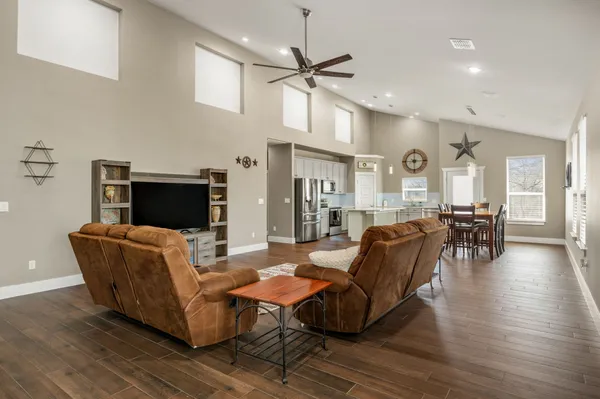 a living room with furniture and a wooden floor