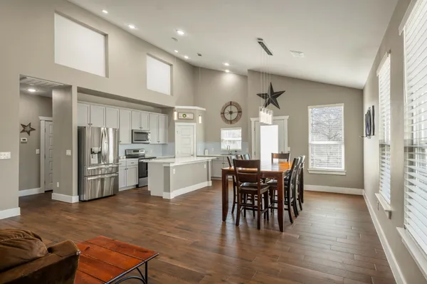 a view of a dining room with furniture and chandelier
