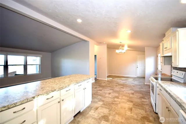 a bathroom with a granite countertop sink a bathtub and a shower