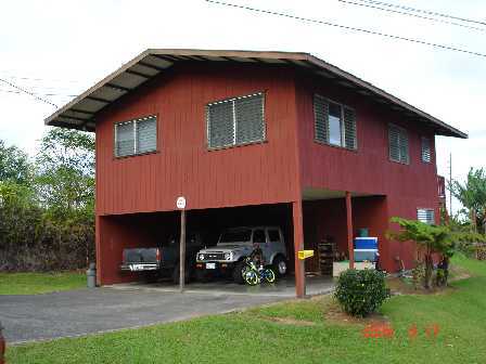28-3012 Andrade Road Pepeekeo, HI 96783 - Photo 4 of 4 a house view with a garden space and a car parked in front of it