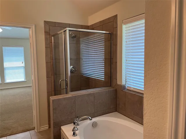 a bathroom with a tub and shower