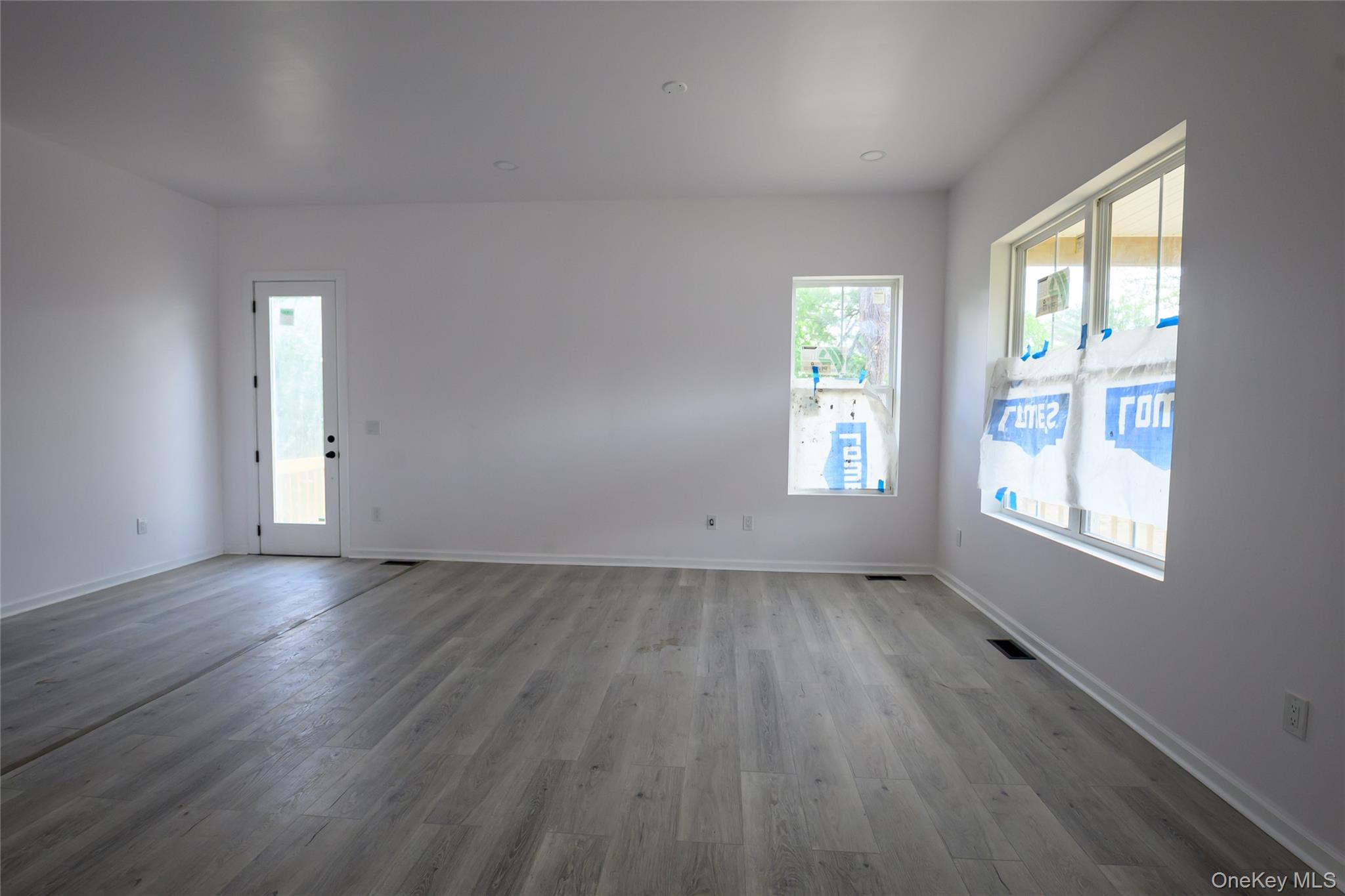 81 Silver Lake Sctn Road Middletown, NY 10940 - Photo 16 of 37 an empty room with wooden floor and windows