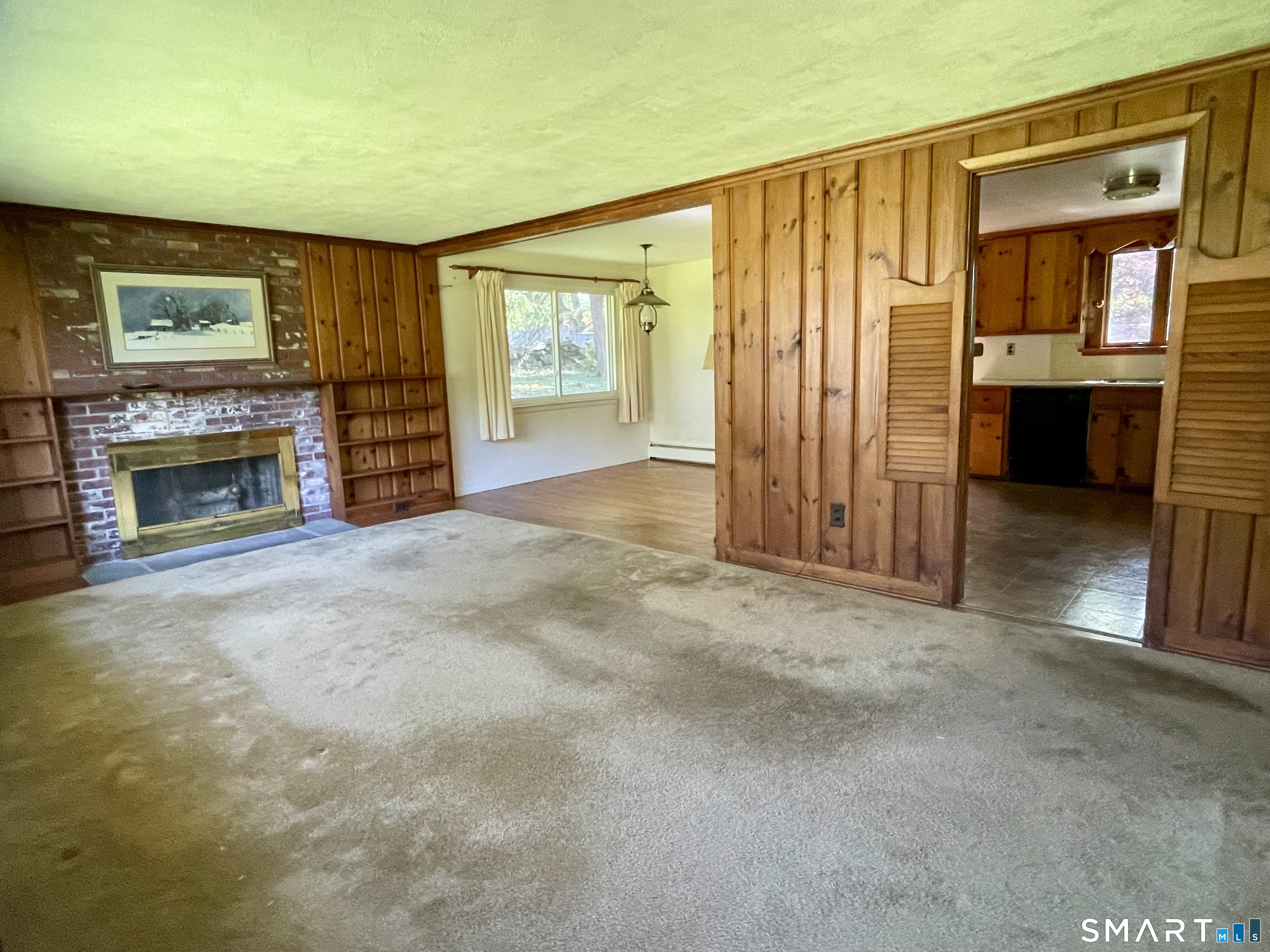 9 Apple Lane Redding, CT 06896 - Photo 20 of 39 Living room has a fireplace with built-in bookcases