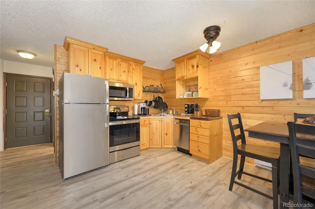 a kitchen with a sink appliances and cabinets