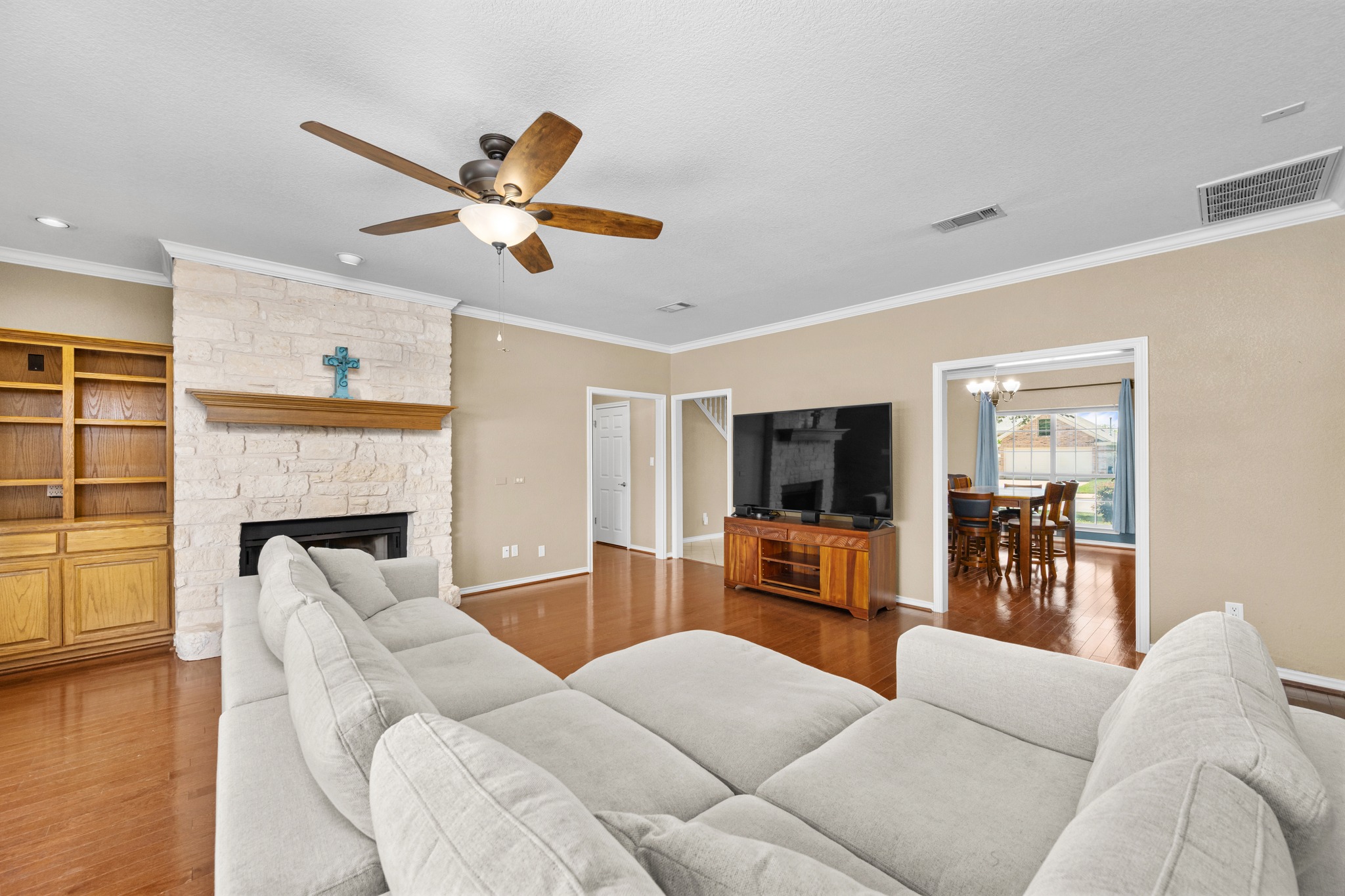 108 Thornwood Road Georgetown, TX 78628 - Photo 11 of 40 A welcoming living area with a stone fireplace and rich hardwood flooring awaits.