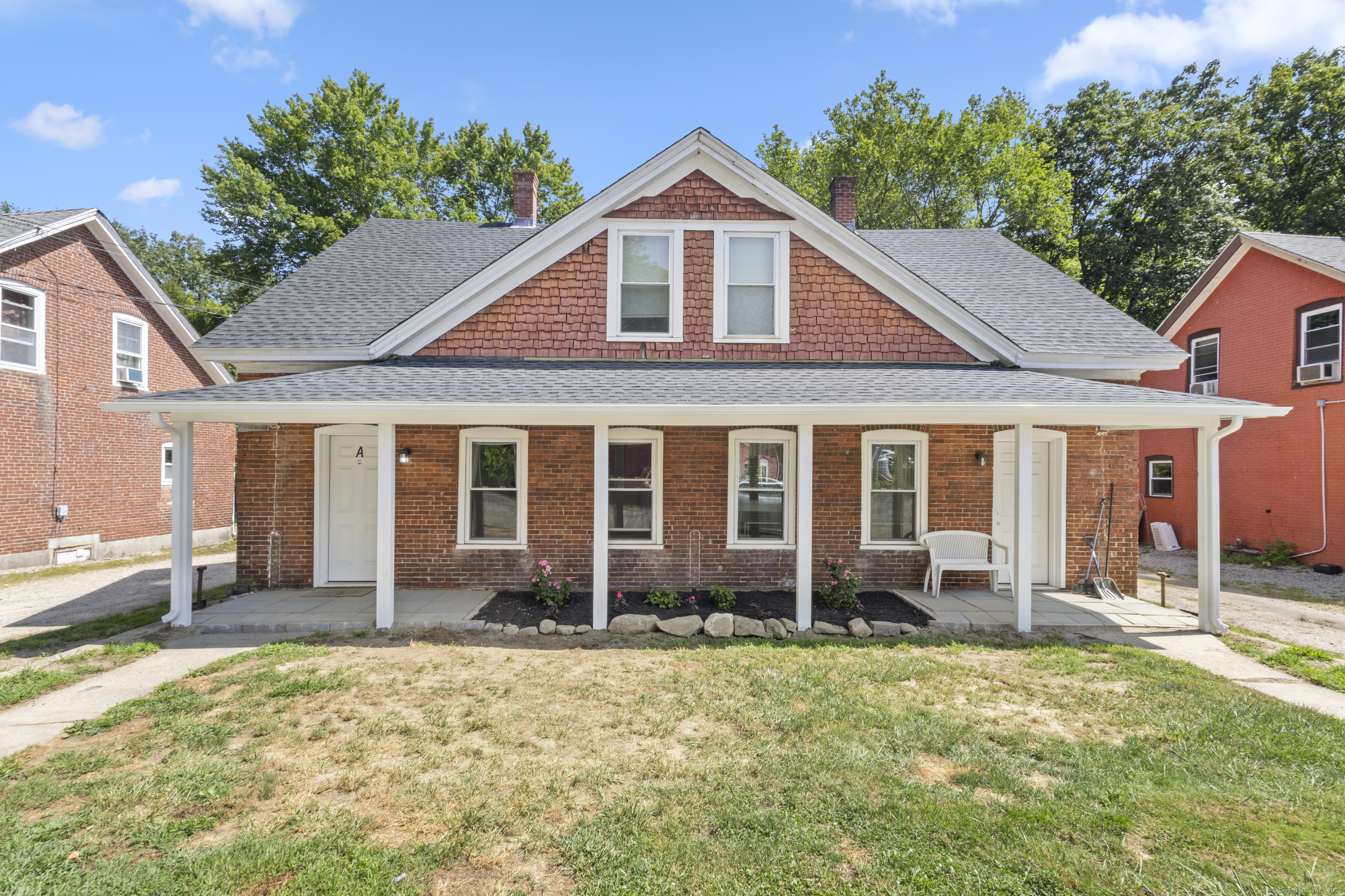 a front view of a house with a yard outdoor seating and barbeque oven