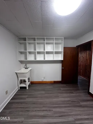 a view of a room with wooden floor and a window