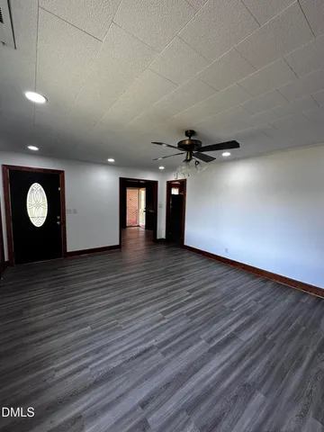 a view of a room with wooden floor