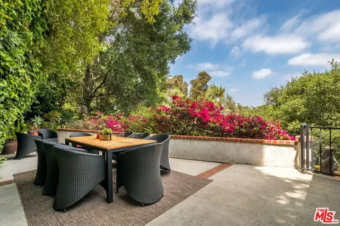 a table and a potted plant sitting on the side of the road