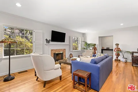 a living room with furniture fireplace and a flat screen tv