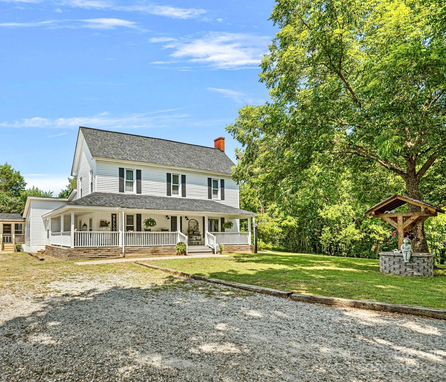 2080 Mountain Road Cleveland, NC 27013 - Photo 1 of 46 a front view of a house with a yard table and chairs