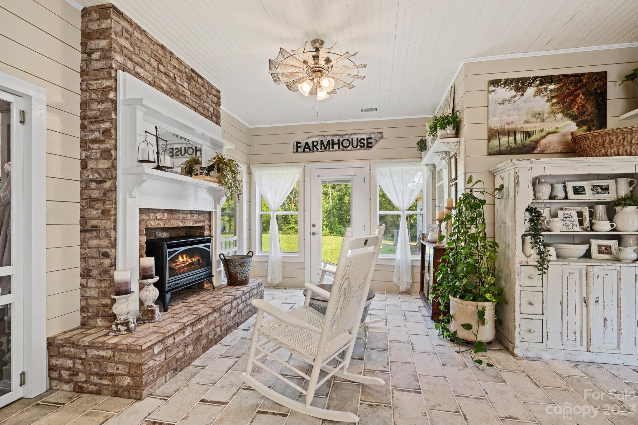 2080 Mountain Road Cleveland, NC 27013 - Photo 18 of 46 a living room with furniture a fireplace and a potted plant