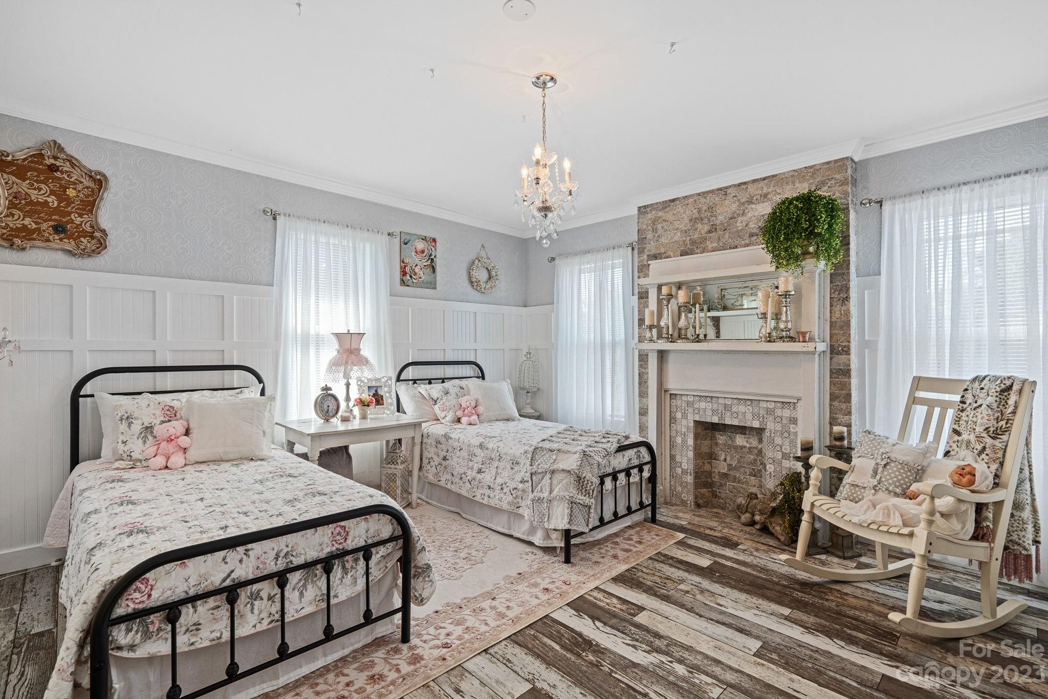 2080 Mountain Road Cleveland, NC 27013 - Photo 32 of 46 a bedroom with two beds and a chandelier