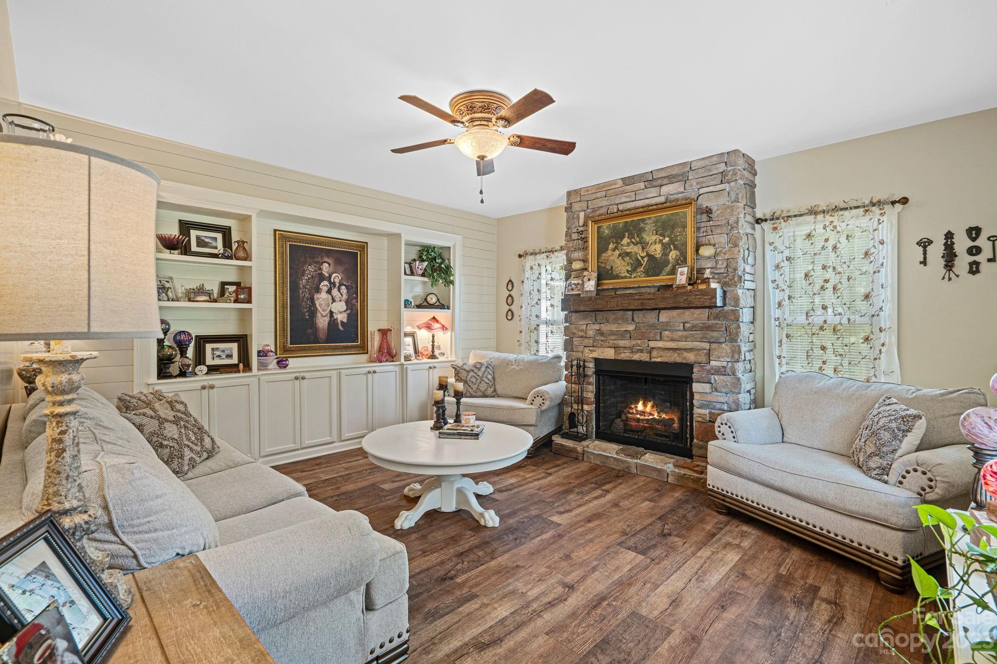 2080 Mountain Road Cleveland, NC 27013 - Photo 8 of 46 a living room with furniture a fireplace and a flat screen tv