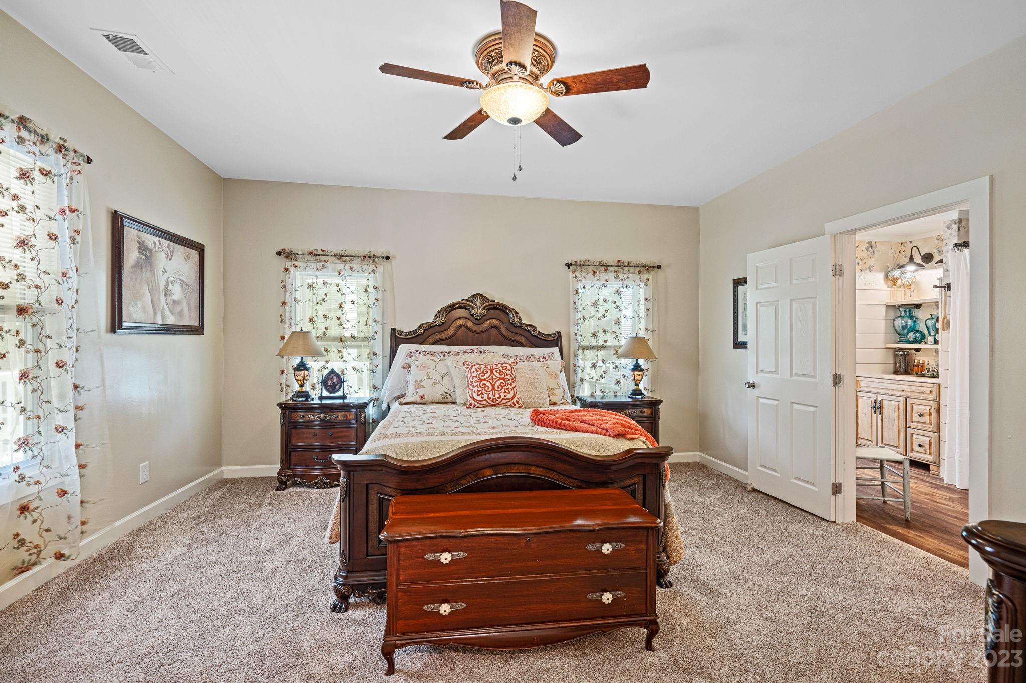 2080 Mountain Road Cleveland, NC 27013 - Photo 9 of 46 a bedroom with a bed and a chandelier