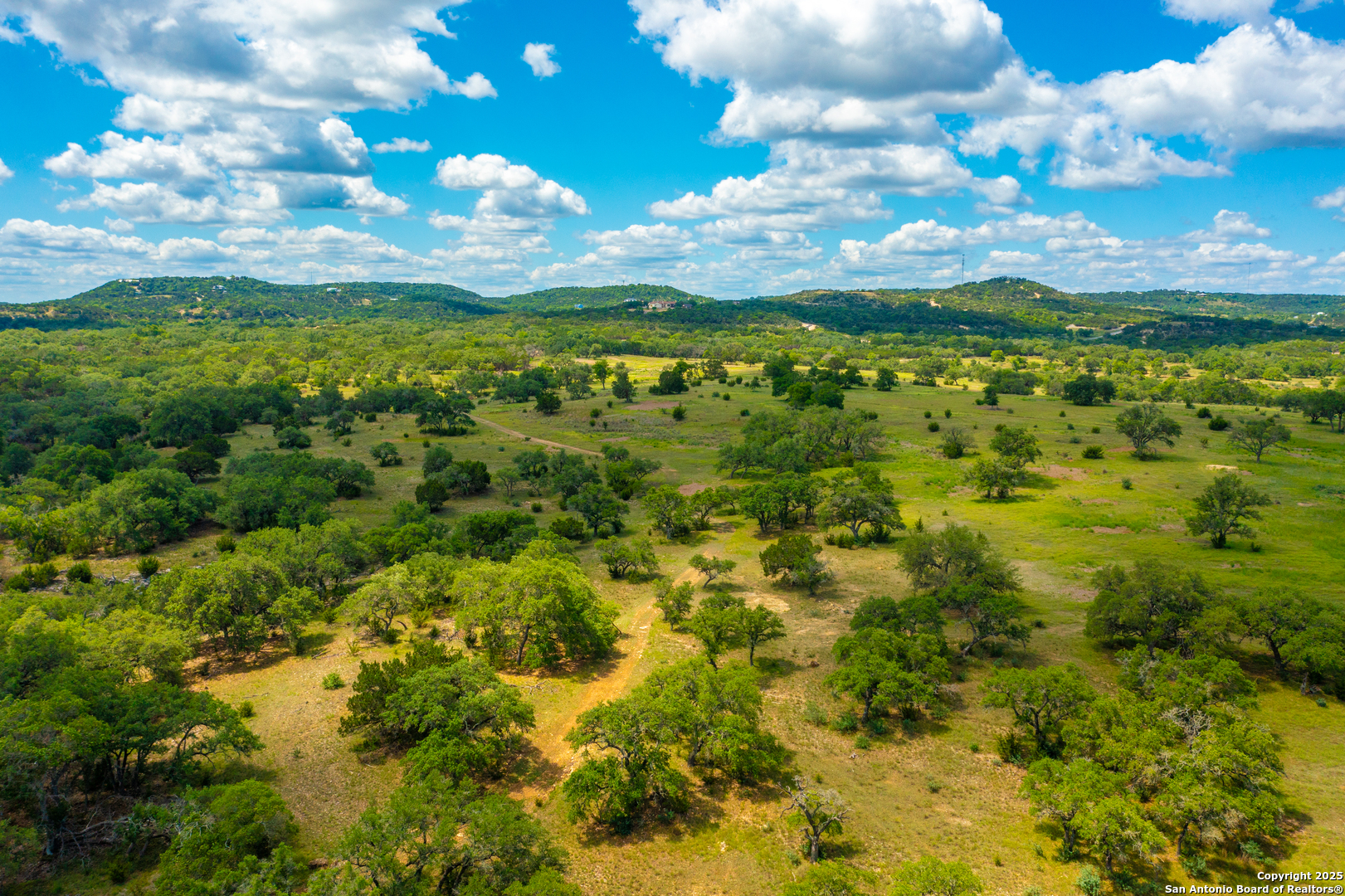 a view of a big yard with lots of green space