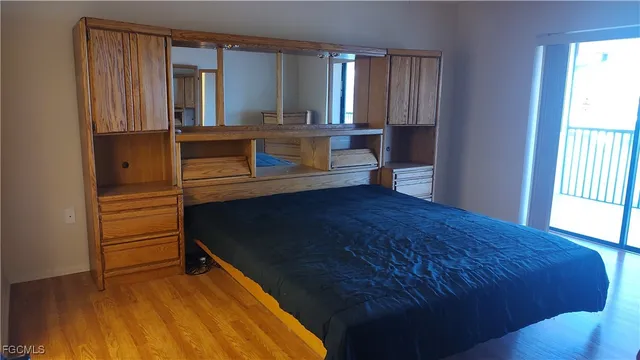 a bedroom with a bed window and mirror
