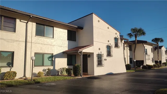 front view of a house with a yard and a large window