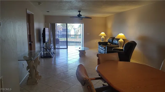 a living room with furniture a lamp and a window