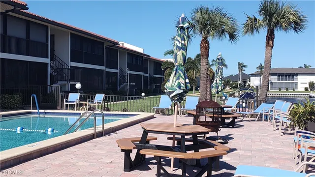 a view of a patio with table and chairs potted plants with wooden floor