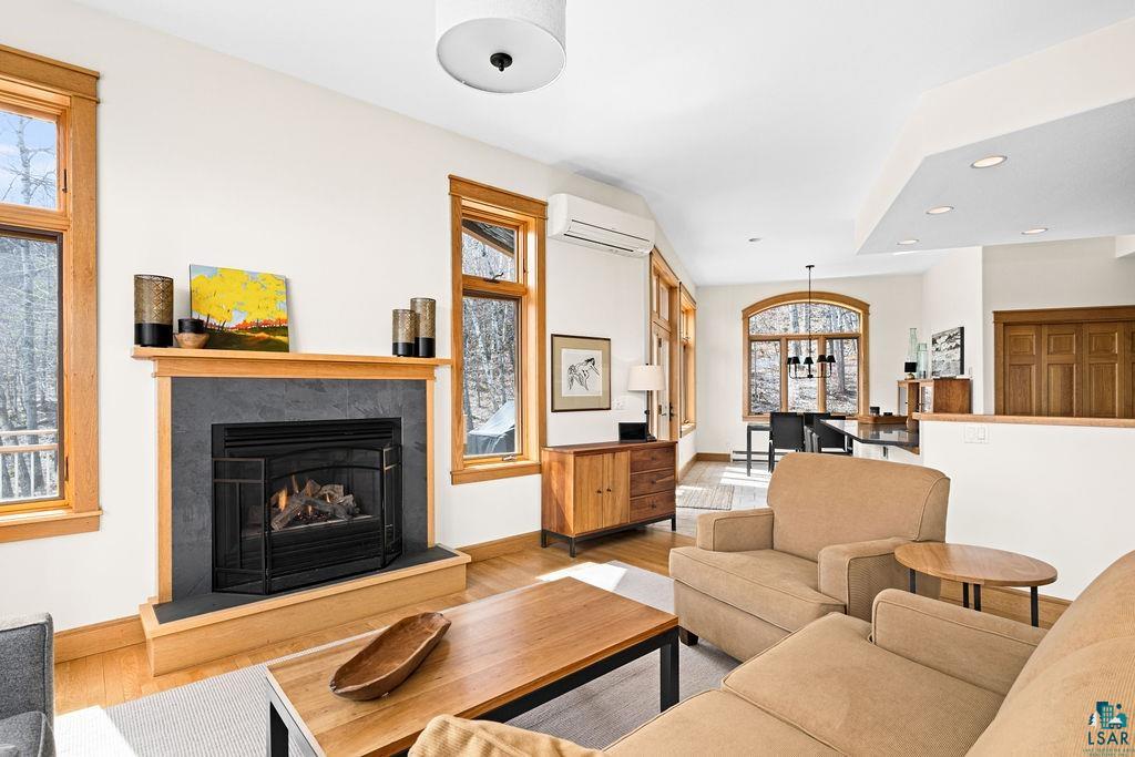 4856 Kingston Street Duluth, MN 55804 - Photo 6 of 88 Living area featuring a black-faced fireplace with a stone surround and wood mantle