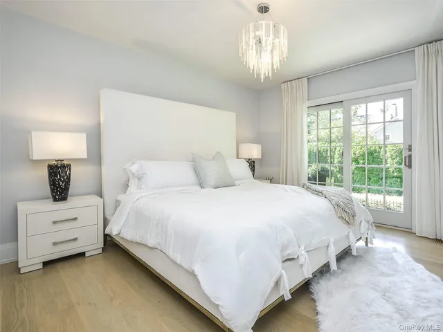 a bedroom with a bed and a chandelier