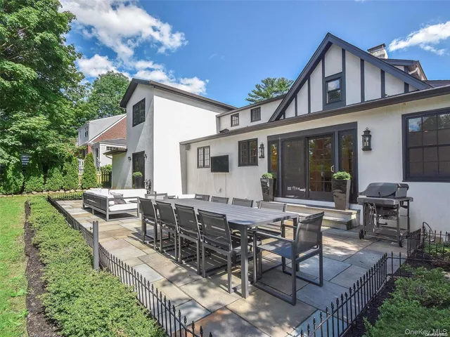a view of a house with backyard and sitting area