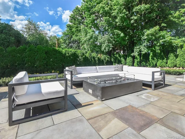 a view of a patio with a table and chairs