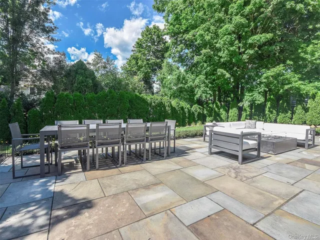 a view of a patio with a table and chairs