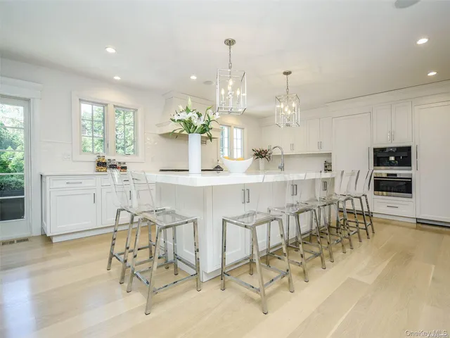 a kitchen with kitchen island granite countertop a table and chairs in it