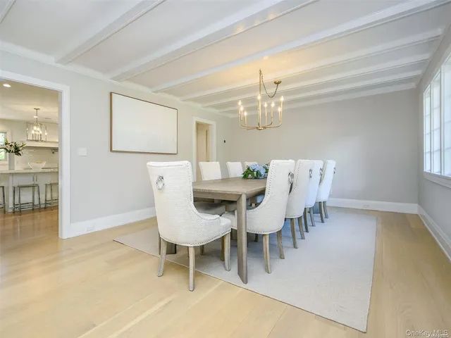 a dining room with furniture and chandelier