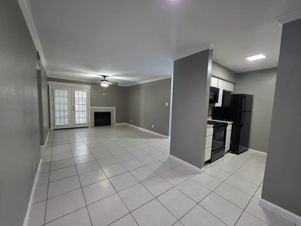 a view of kitchen with furniture and refrigerator