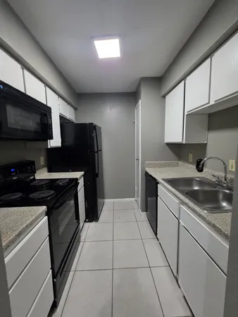 a kitchen with stainless steel appliances granite countertop a sink stove and microwave