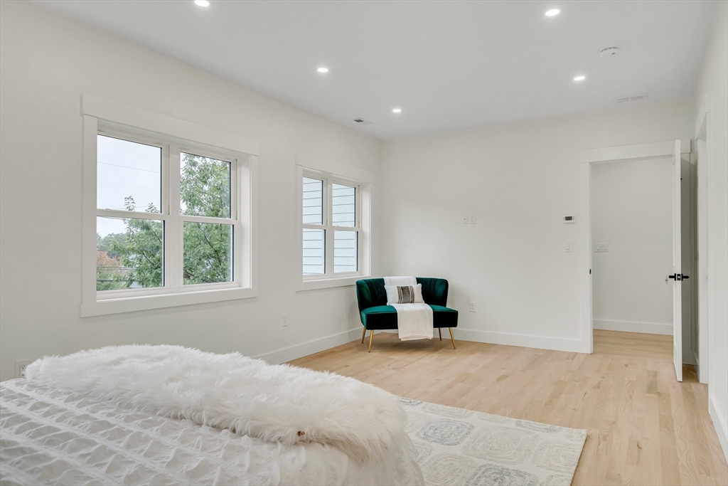 22 Estabrook Road Lexington, MA 02421 - Photo 22 of 36 a bedroom with a bed and a large window