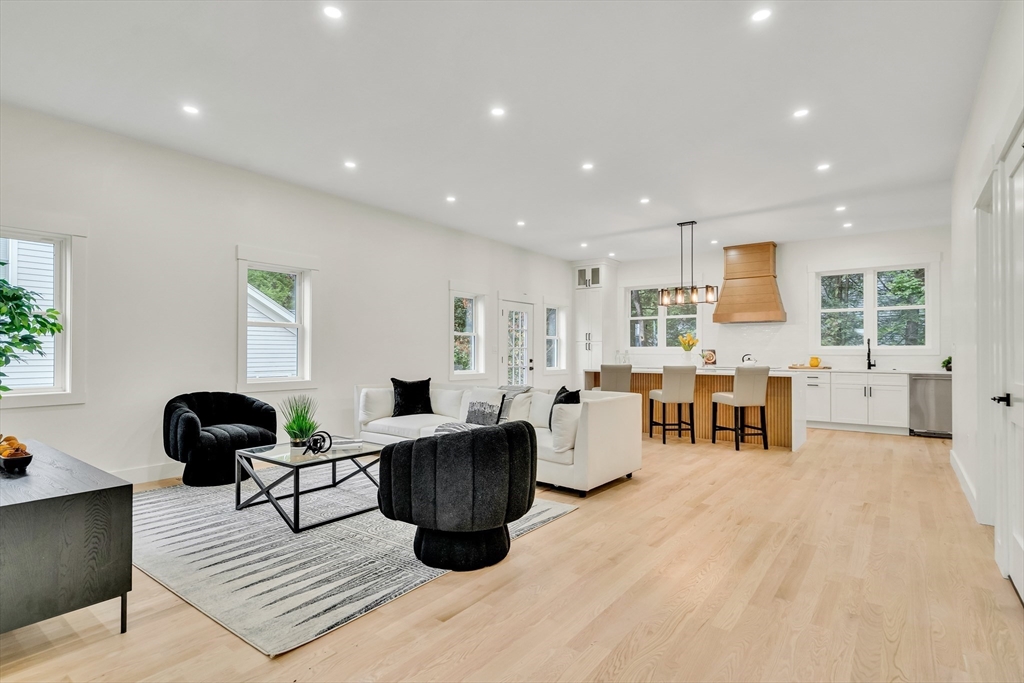 22 Estabrook Road Lexington, MA 02421 - Photo 8 of 36 a living room with lots of furniture and view of kitchen