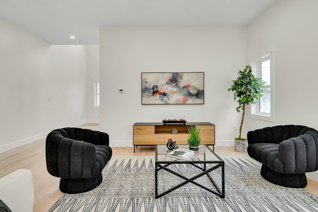22 Estabrook Road Lexington, MA 02421 - Photo 10 of 36 a living room with furniture and a chair