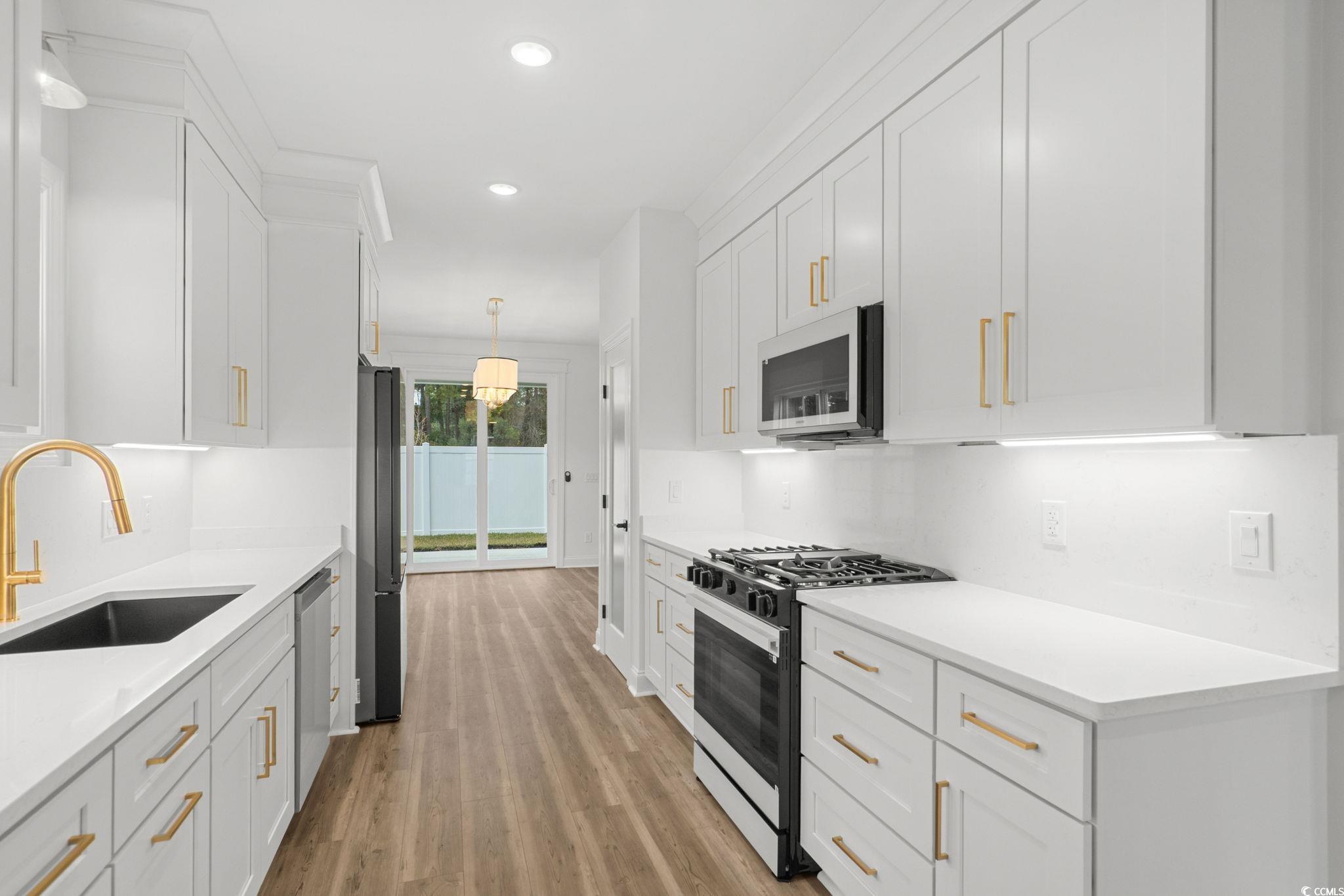 164 Arbor Ridge Circle Conway, SC 29526 - Photo 12 of 38 Kitchen with gas range oven, white cabinetry, decorative light fixtures, recessed lighting, and light wood-style flooring